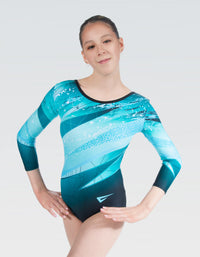 A long sleeve gymnastics leotard in turquoise color with a geometric pattern, worn by a female model.