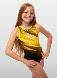 A sleeveless yellow gymnastics leotard with a geometric pattern, worn by a young female model with long hair.
