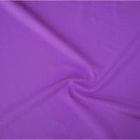 A close-up of draped purple fabric with soft folds and a satin-like sheen.