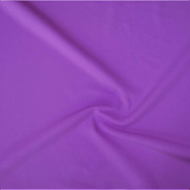 A close-up of draped purple fabric with soft folds and a satin-like sheen.
