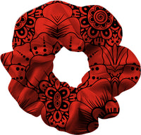 Red scrunchie with black intricate patterns on a white background