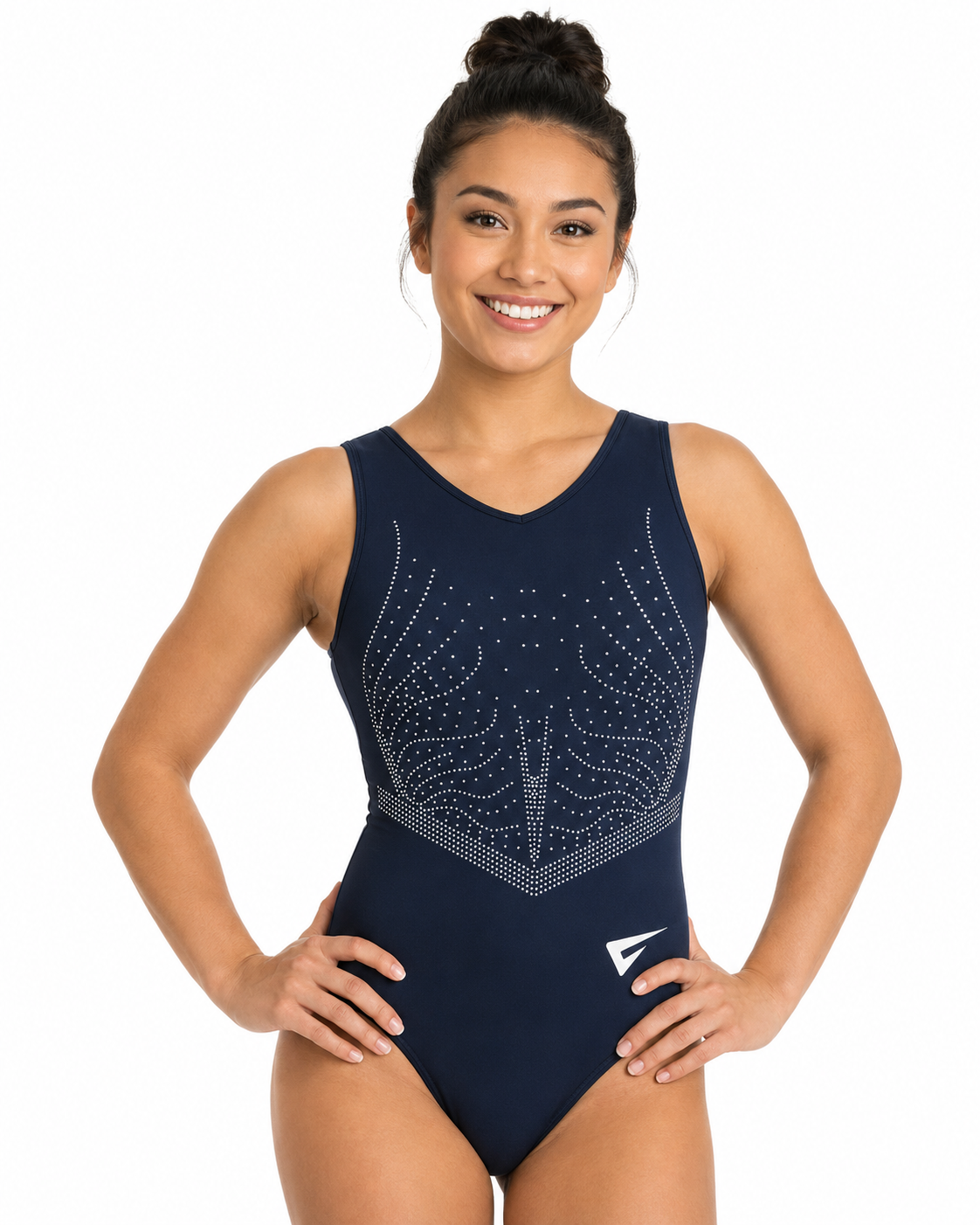 A smiling young woman modeling a navy blue sleeveless leotard with silver rhinestone wing patterns on the chest and a white logo near the lower front, set against a plain white background.
